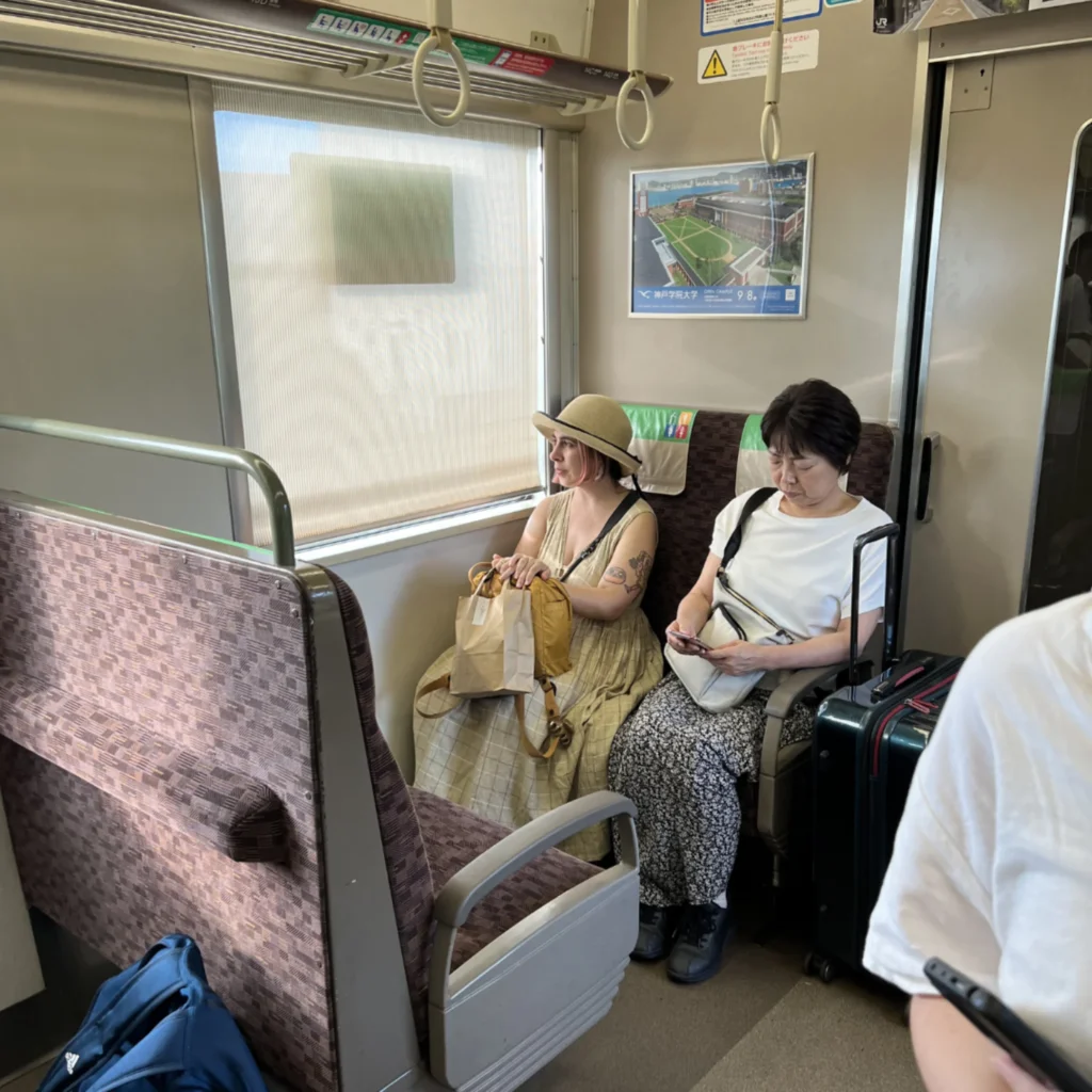 personas sentadas dentro de tren japonés usando transporte público en Japón